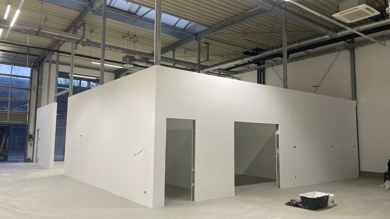 Fertige weiße Trockenbau-Trennwände mit Türöffnungen in einer Halle